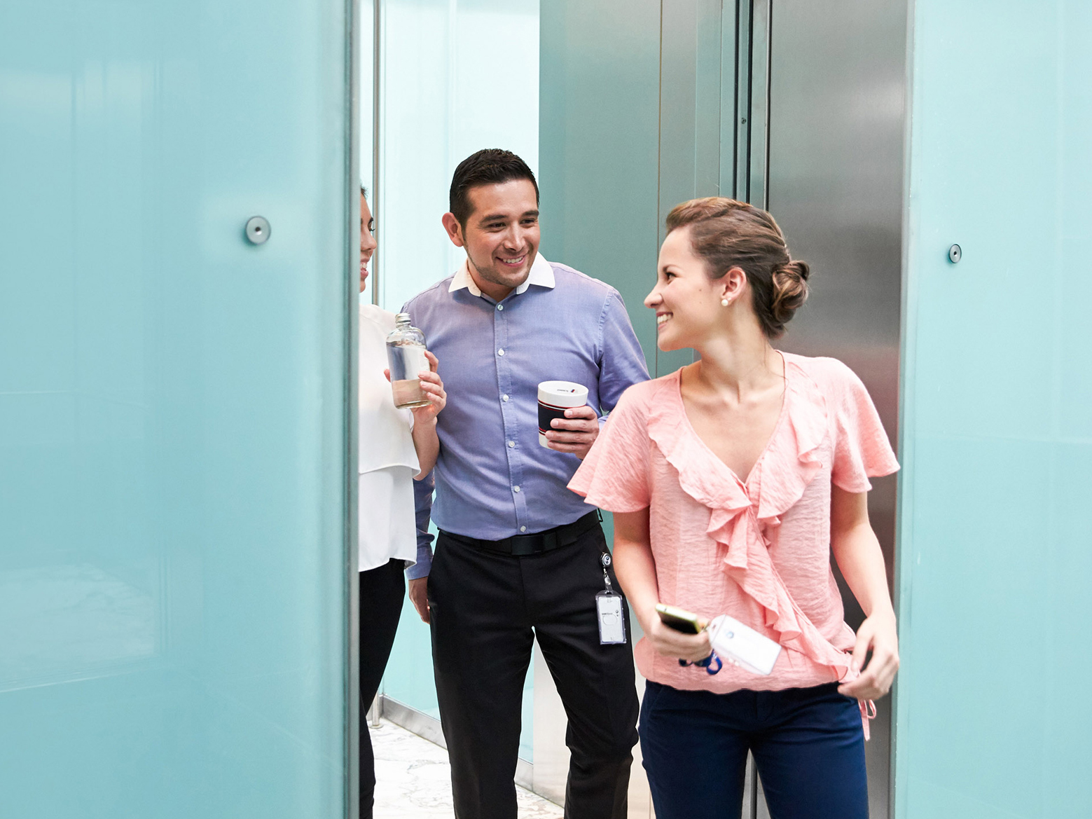  The picture shows three happy BMW employees returning to the office from their lunch break.