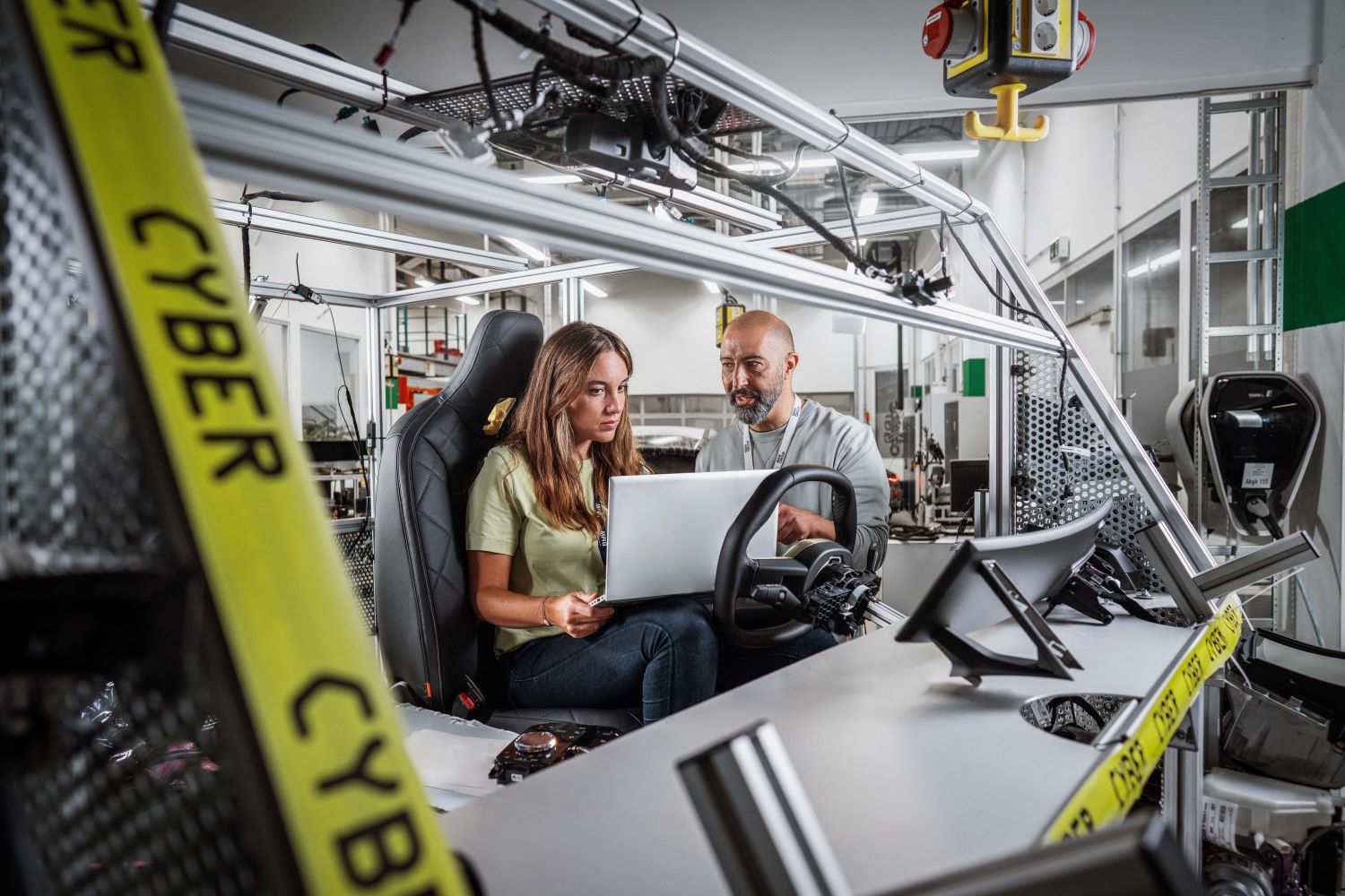 A woman who works in IT Security at BMW discusses something with her colleagues.