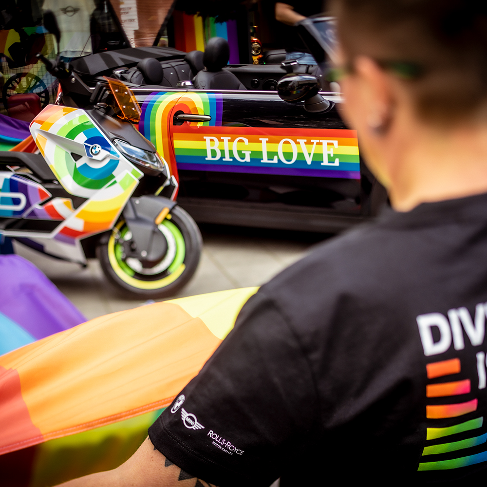 A MINI and a motorbike painted in rainbow colors.