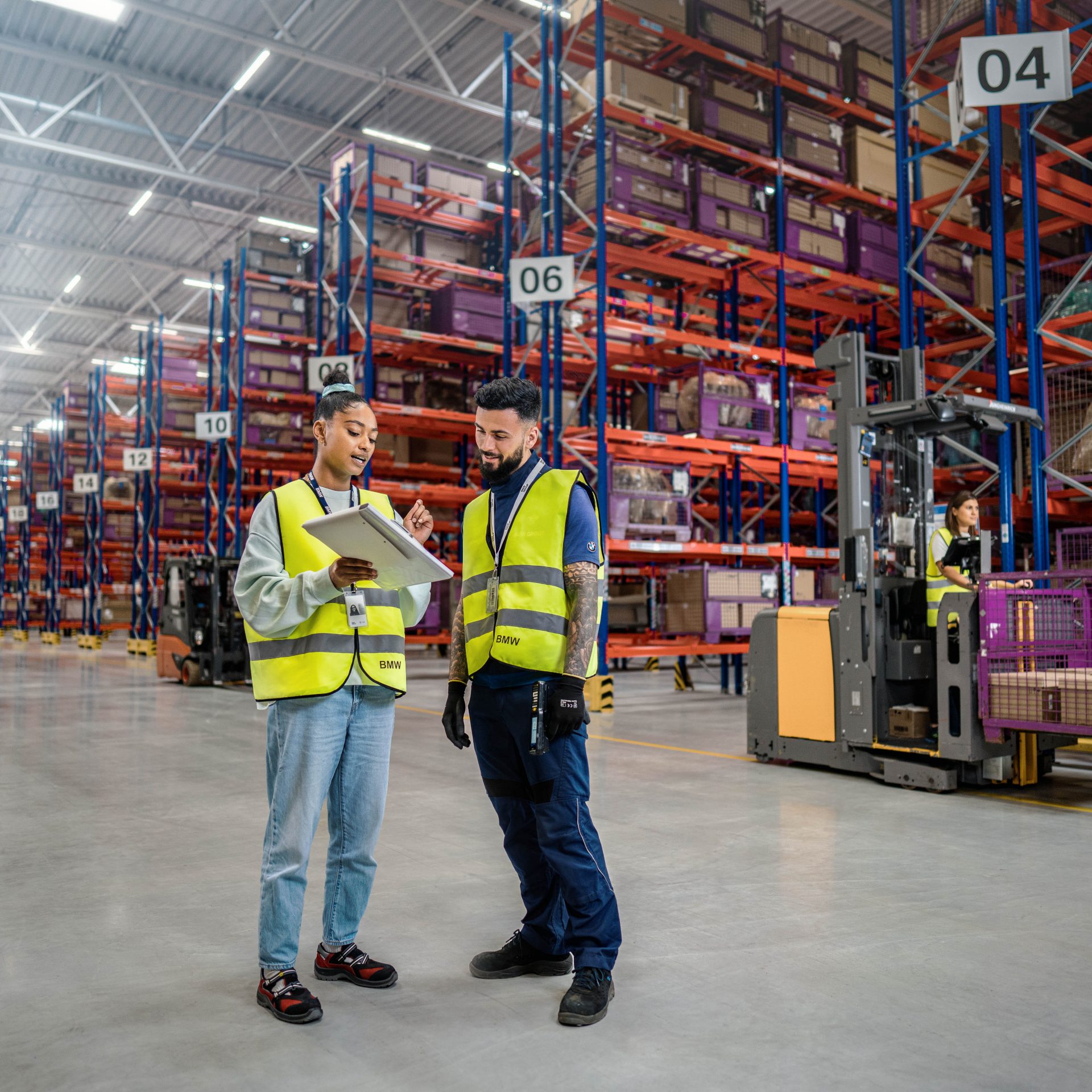 Das Bild zeigt zwei BMW Mitarbeiter in der Logistik.