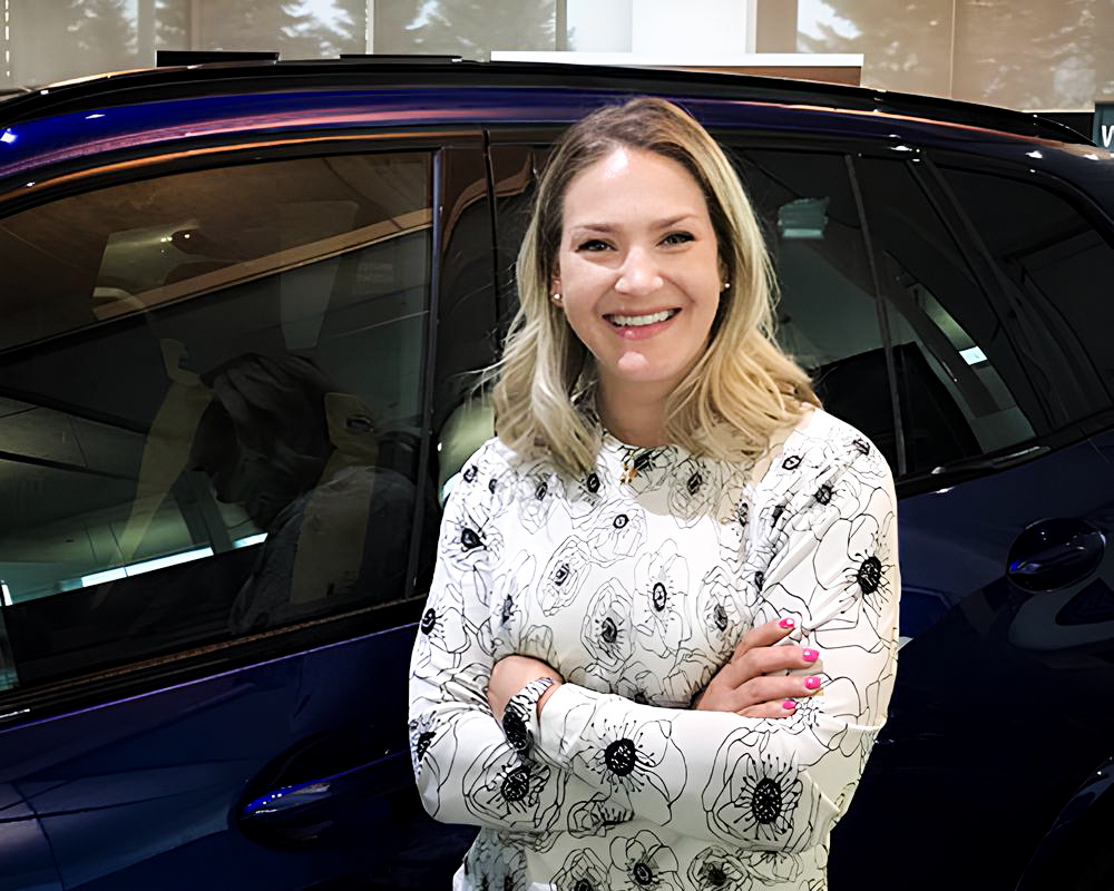 The image shows Holly Strobel, a Retailer CRM Systems Manager at the BMW Group Canada.