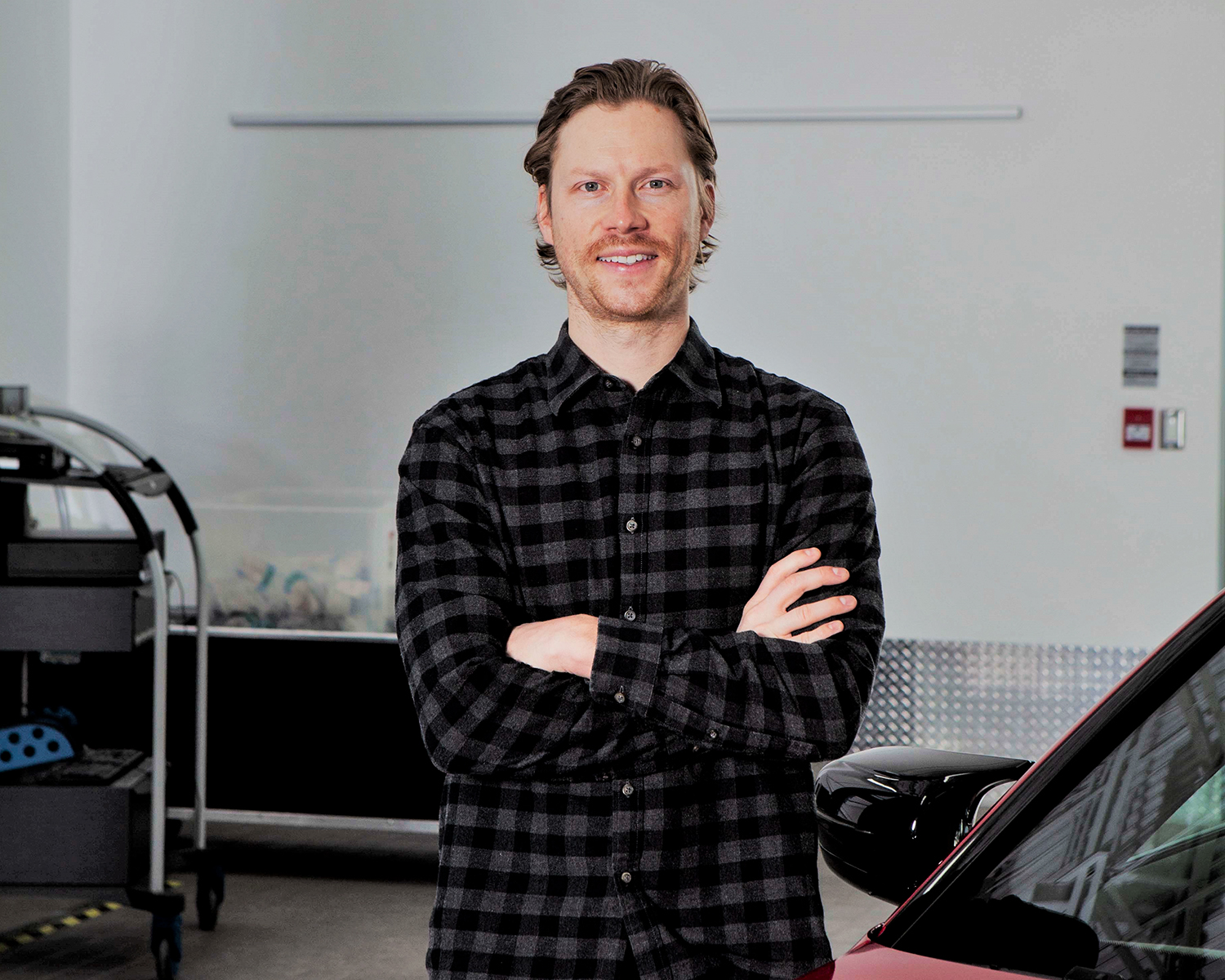 The image shows Alex Welsh, a Motorrad Marketing Coordinator at the BMW Group Canada.