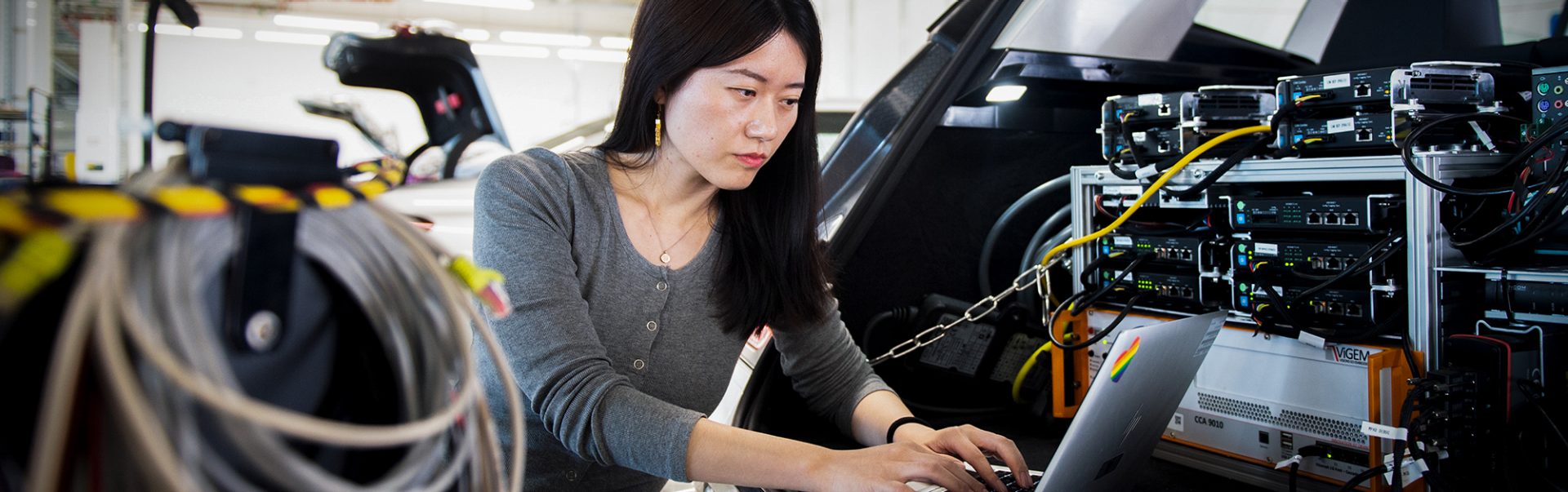 A female software specialist working on car software.