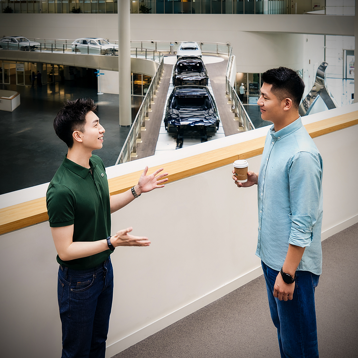 The picture shows two students working together at BMW.
