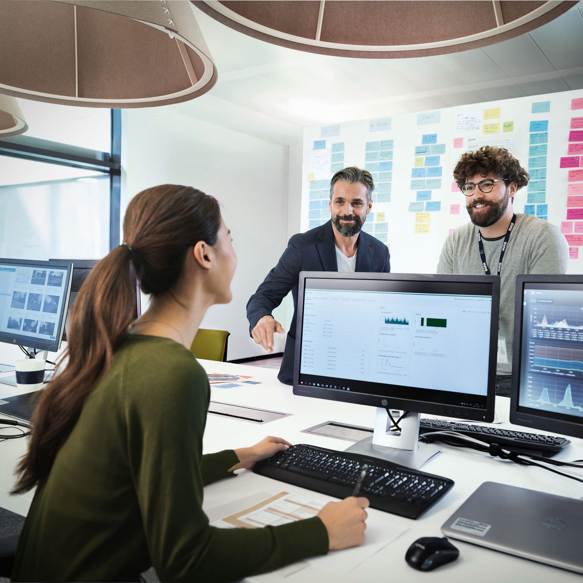 BMW IT Employees using advanced technology for project collaboration.