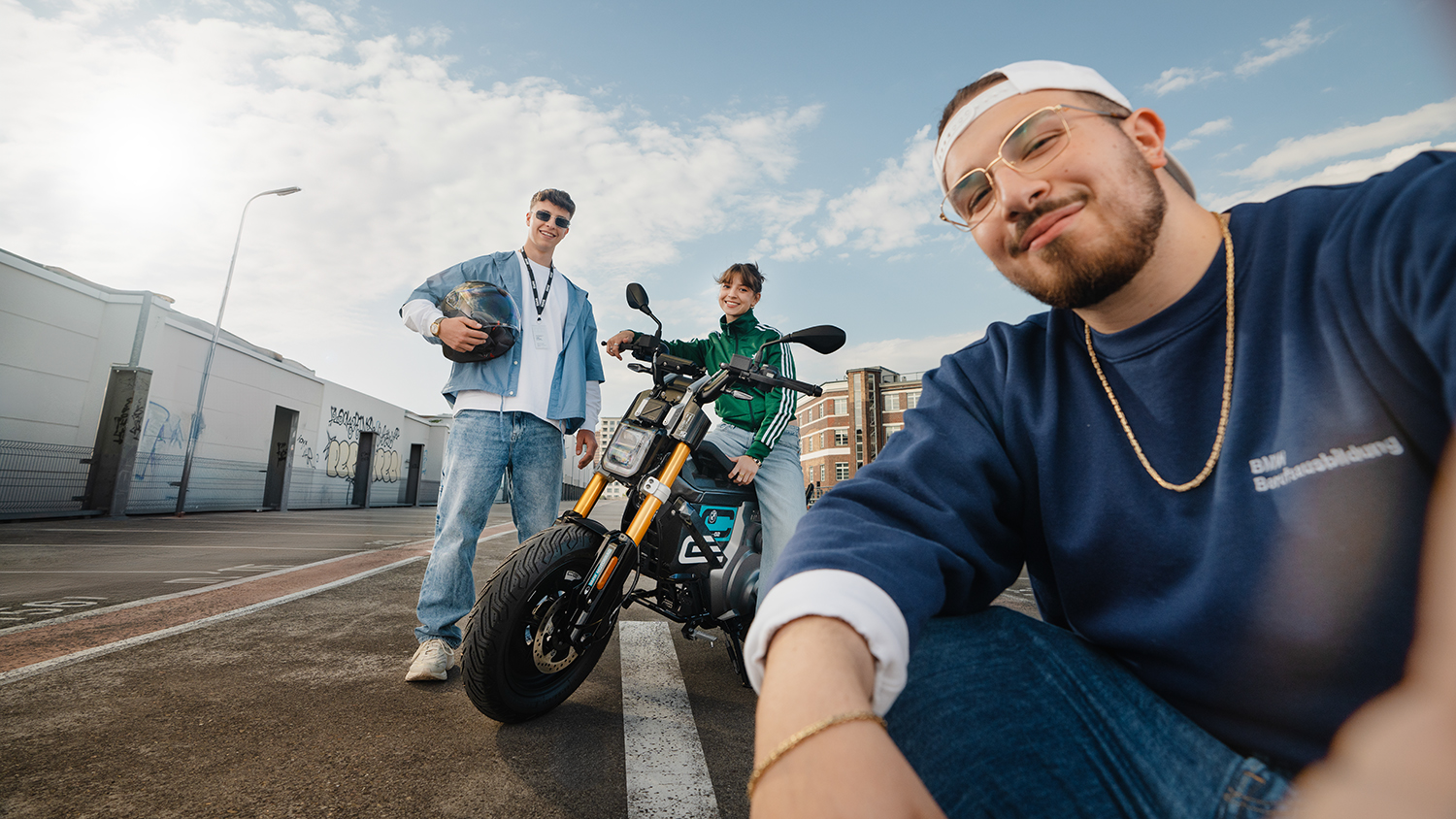 Three apprentices with a BMW Motorrad in Berlin