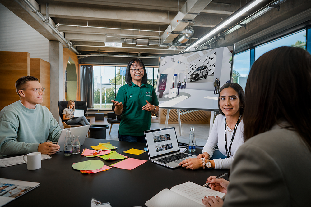 Four BMW Group employees planning an event.