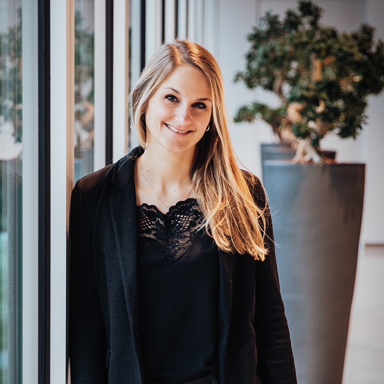 In-house counsel for BMW Group Compliance smiles into the camera.
