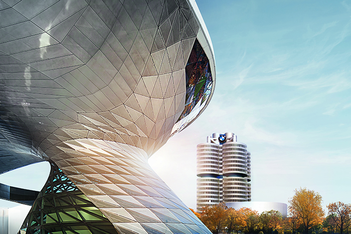 Extorior view of the BMW World with the BMW Four-Cylinder in the Background.