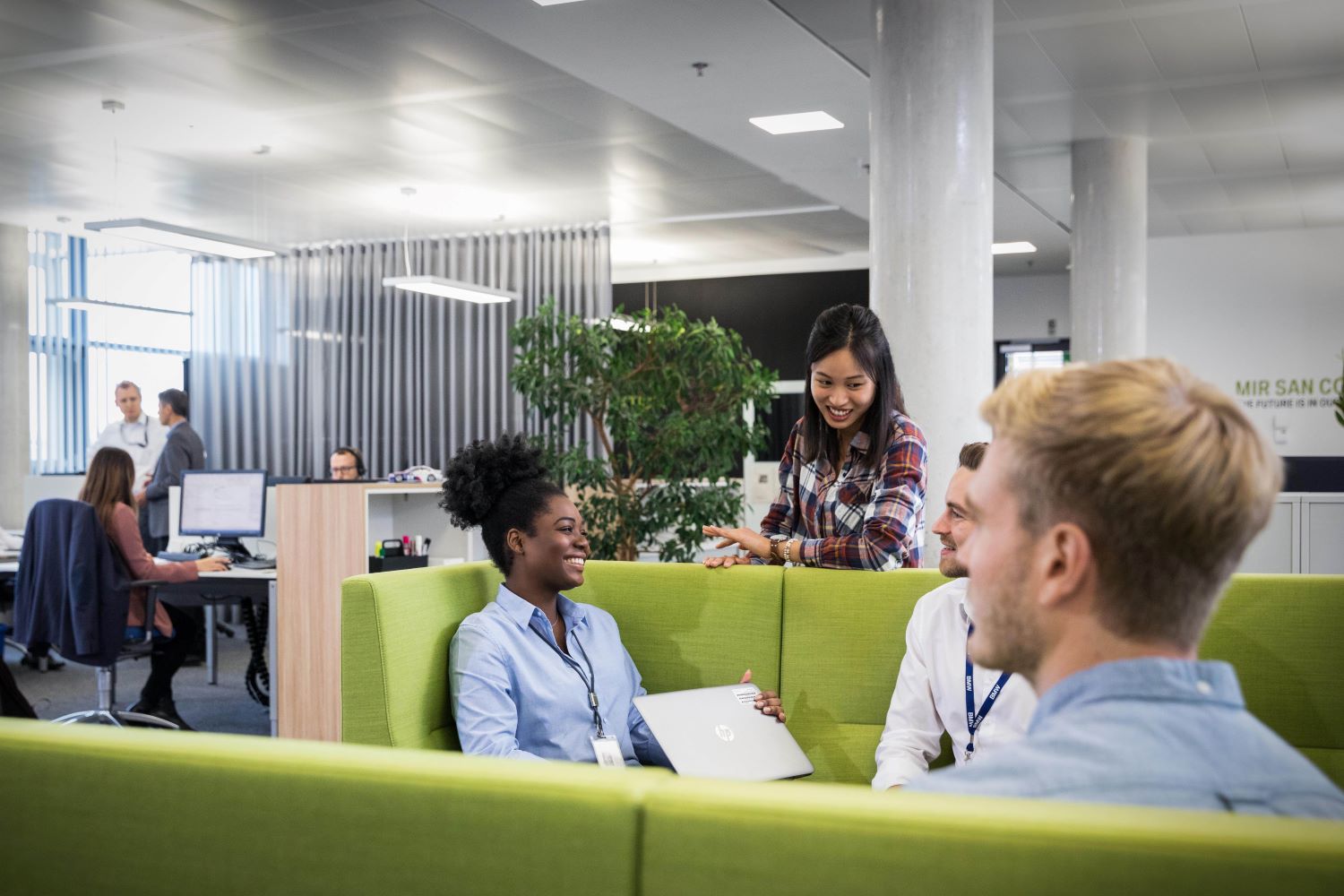 Four BMW Group colleagues having a chat in the office.