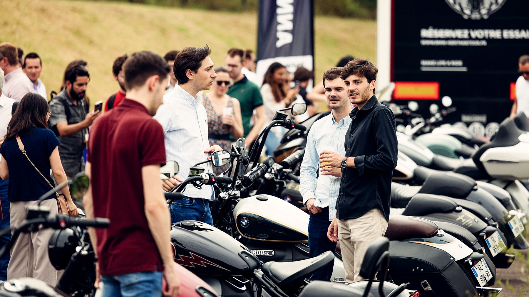 Students at a career fair with BMW motorbikes.