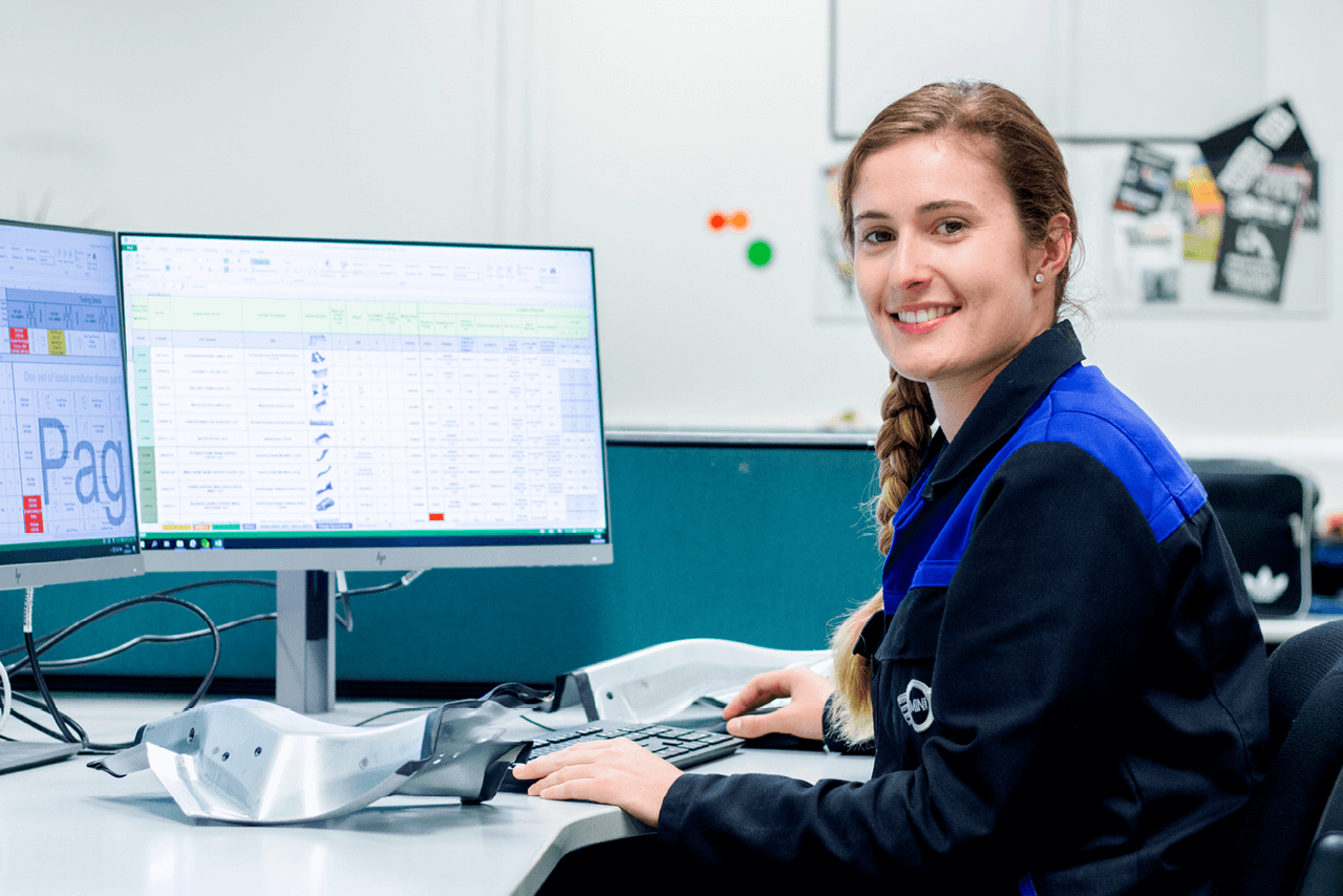 Danielle, an apprentice technician, working on a computer at the MINI Plant Swindon