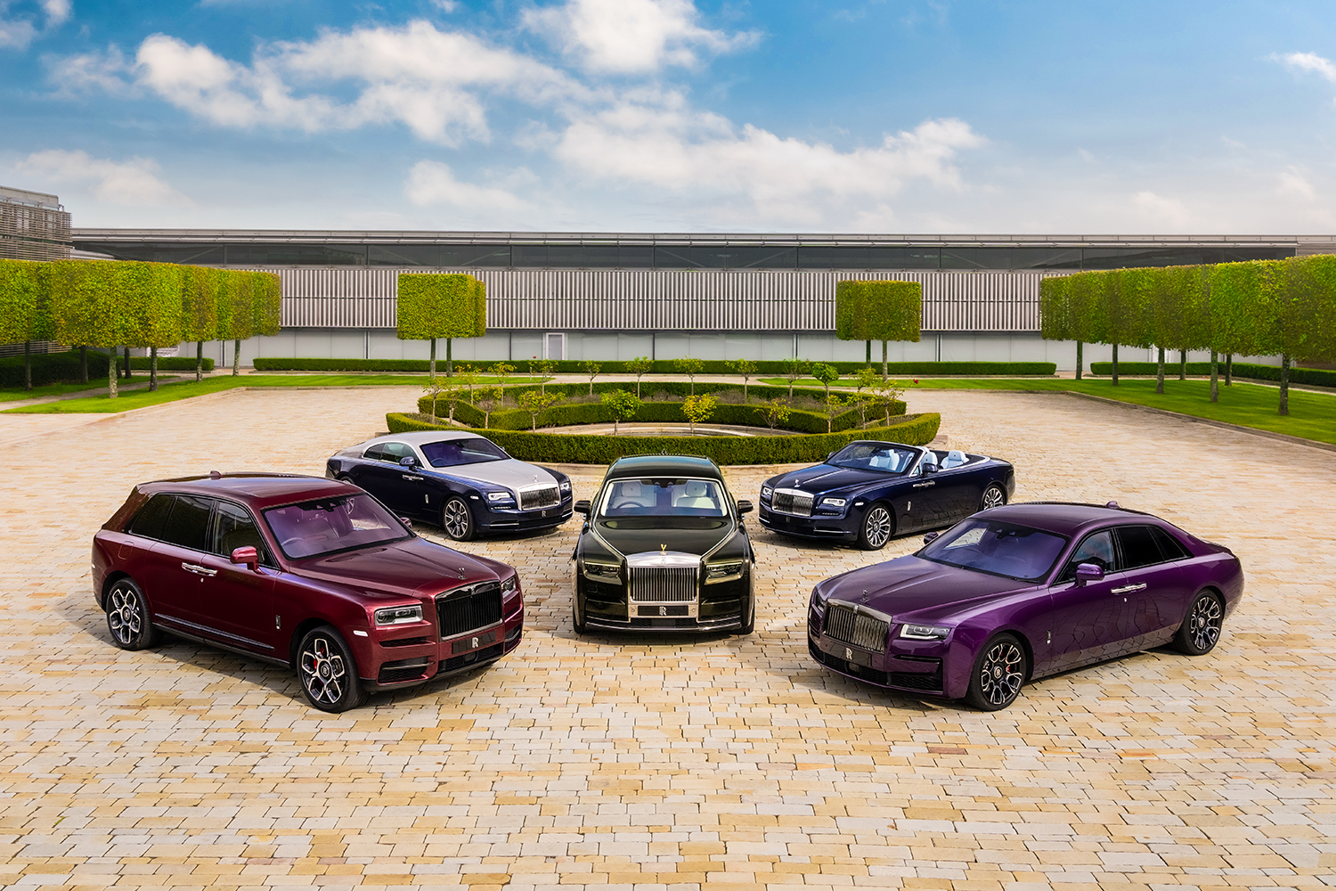 Five Rolls-Royce cars in front of the production site in Goodwood