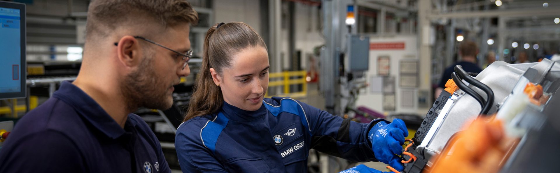 A BMW Group technical apprentice and teacher at work.