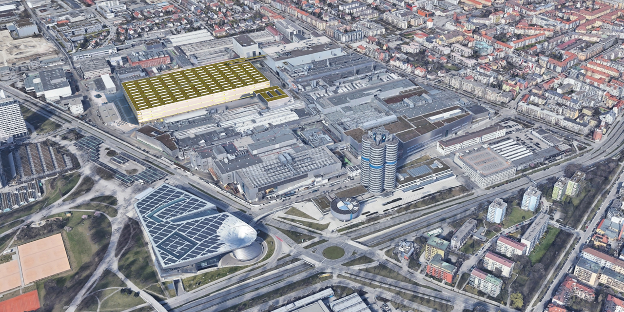 The image shows an aerial view of the BMW plant and headquarters in Munich.
