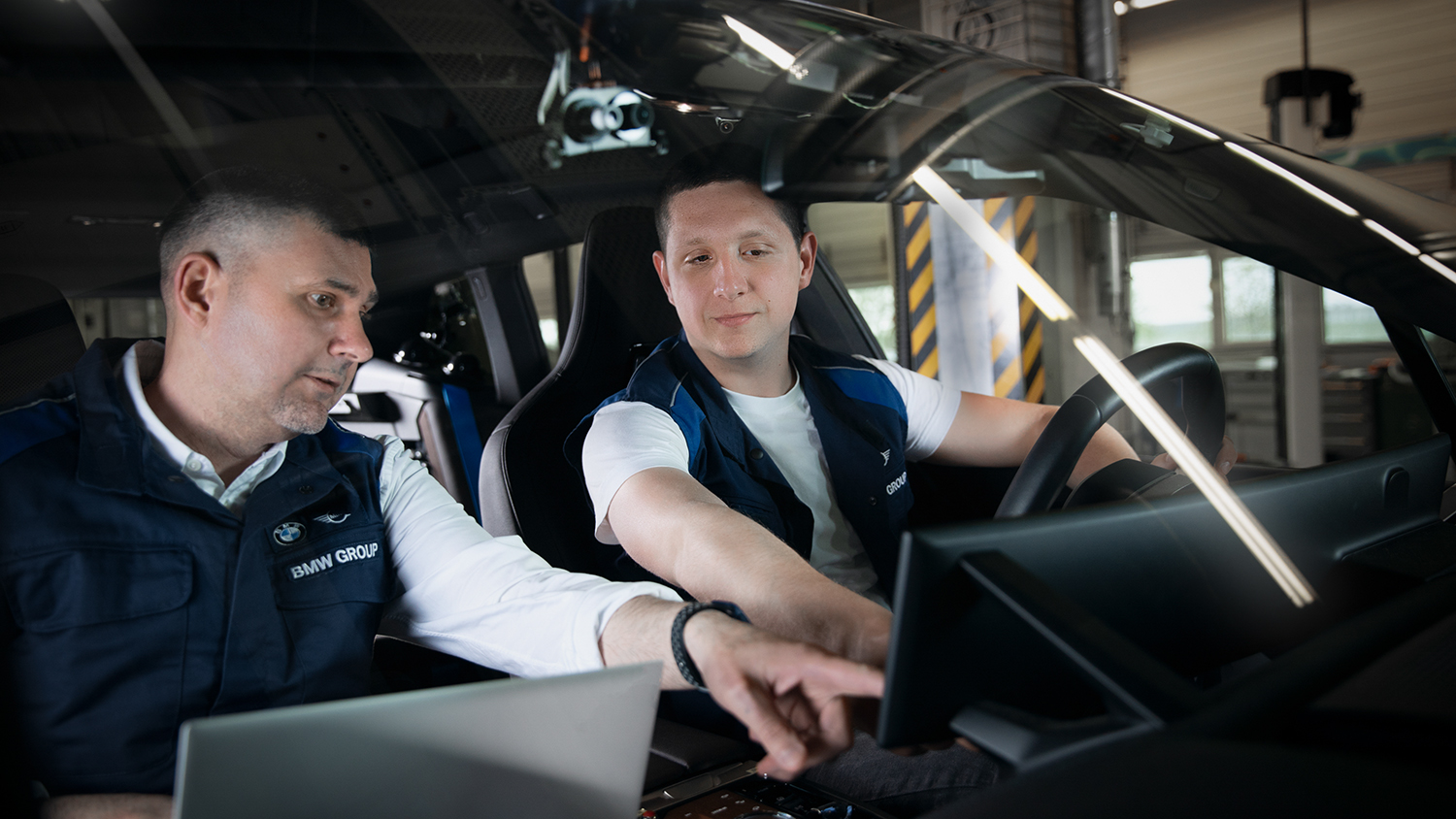 Two colleagues working in a car