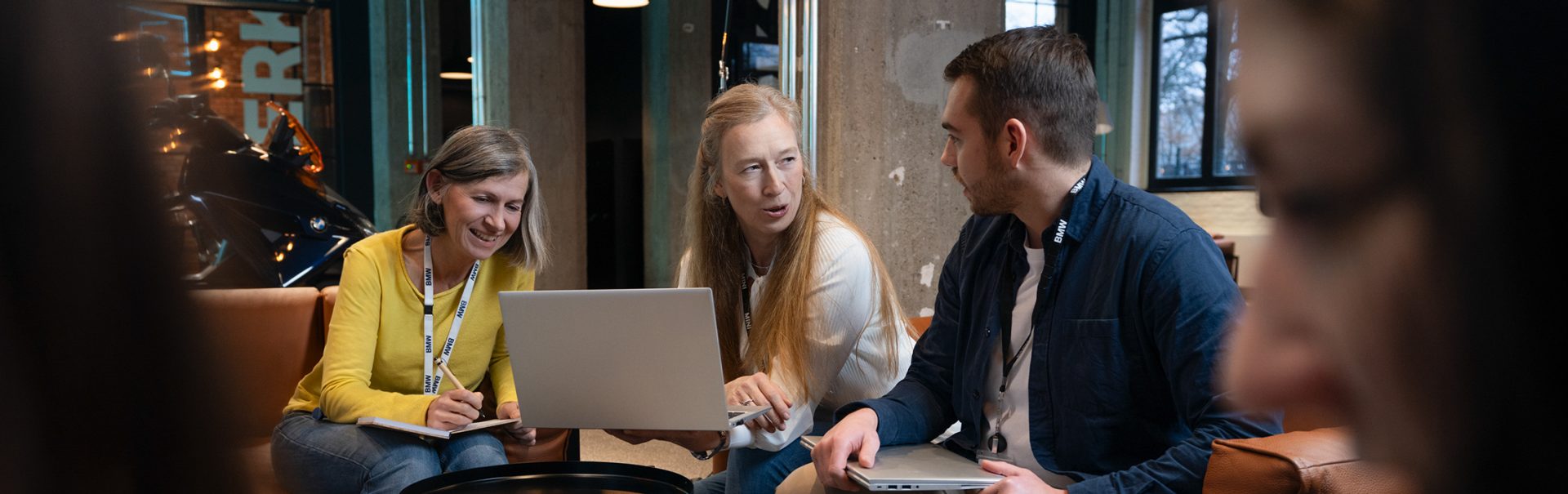 Three colleagues talking about benefits